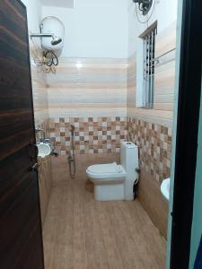 a bathroom with a toilet and a sink at HOTEL MOON-LITE in Guwahati