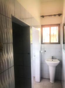 a bathroom with a sink and a toilet at Tatys homestay in Dar es Salaam