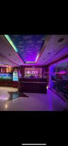 a room with a bar with purple lights at Gia Bảo Hotel - 234/3 Bạch Đằng, Q.Bình Thạnh - by Bay Luxury in Ho Chi Minh City