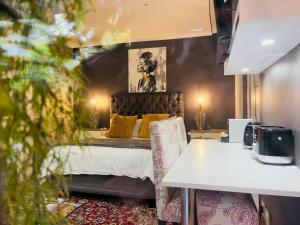 a bedroom with a bed with yellow pillows at Art-Inspired Bedroom Close to CBD in Mossel Bay