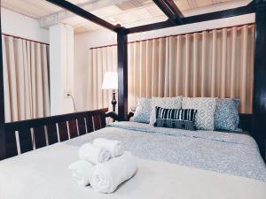 una camera da letto con un letto e asciugamani di Green Riverside Homestay a Phra Nakhon Si Ayutthaya