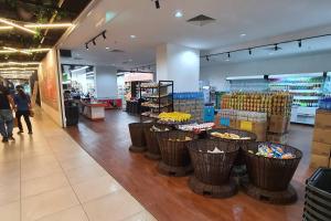 a grocery store with baskets in the middle of a aisle at Kozi Square comfort Studio Home 2D in Kuching