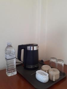 uma máquina de café e uma garrafa de água numa bandeja em Hotel Vibe by Solitary em Pokhara