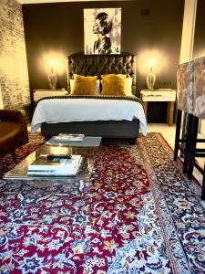 a bedroom with a bed and a large rug at Art-Inspired Bedroom Close to CBD in Mossel Bay