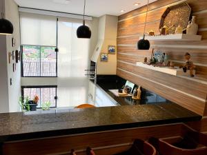 a kitchen with wooden walls and a counter top at Apto Ubatuba home - Centro c vista in Ubatuba