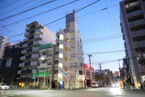 a building on a city street with a red traffic light at Skytree Apartment Self Check-in in Tokyo