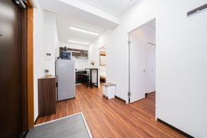 an open hallway with a kitchen and a dining room at Skytree Apartment Self Check-in in Tokyo