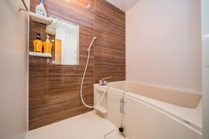 a bathroom with a sink and a bath tub at Skytree Apartment Self Check-in in Tokyo +49 photos