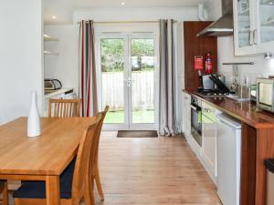 a kitchen with a wooden table and a dining room at Cape A2 in Yarmouth