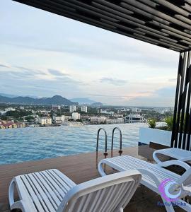 a balcony with chairs and a view of the water at Muji 40 Winks Horizon 3-BR Retreat in Ipoh