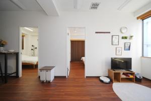 a living room with a bed and a table and a television at Skytree Apartment Self Check-in in Tokyo