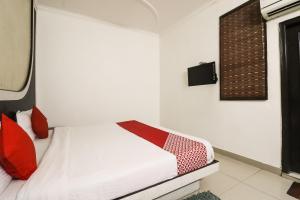 Cama o camas de una habitación en OYO Global Radiance