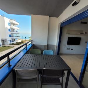 a balcony with a table and chairs and a tv at Apartamento Castillo Bajo in Torrox Costa