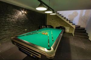 a pool table in a room with a staircase at RED HOUSE in Bakuriani