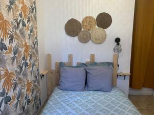 sypialnia z łóżkiem z niebieską poduszką w obiekcie Appartement avec cours w mieście Gien