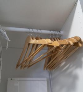 a rack of wooden baseball bats hanging from a ceiling at Blue Rooster Apartment. Cozy and quiet place to stay in Warsaw