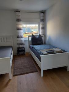 a bedroom with two beds and a window at Ferienwohnung in Erftstadt Phantasialand, Köln, Köln Messe, Eifel in Erftstadt