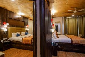 a bedroom with two beds and a ceiling at Beyond Stay Lall Ji Tourist Resort in Dalhousie