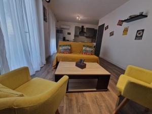 a living room with two beds and a table and chairs at Garissou appart in Béziers