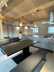 a kitchen with a large black table in a room at ARTISANAL in Naoshima