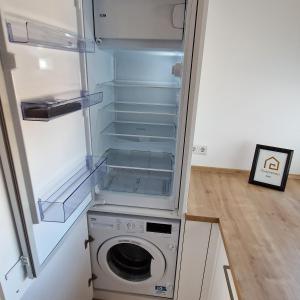 an empty refrigerator with a washing machine in it at PANORAMA INN - nahe Messe contaktless check-in in Hannover