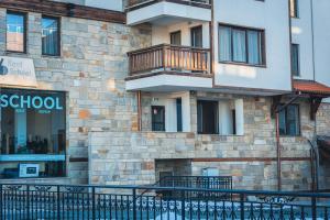 a building with a balcony on the side of it at IG Apartments Royal Towers 426 in Bansko