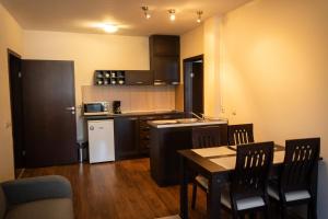 a kitchen with a table and chairs in a room at IG Apartments Royal Towers 426 in Bansko