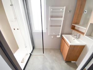 a bathroom with a sink and a mirror at Soleil Levant - Camping Belle-Vue in Berdorf