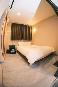 Postel nebo postele na pokoji v ubytování ホテルハーバー心斎橋