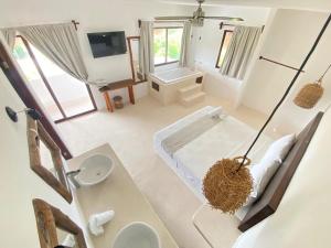 a bathroom with a tub and a toilet and a sink at Mis Sueños Holbox in Holbox Island