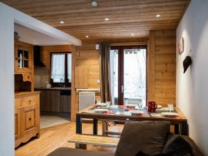 a kitchen with a table in the middle of a room at Bel Appartement 3 Pièces avec Balcon, Proche Centre Châtel, Parking et Connexion WiFi - FR-1-676-119 in Châtel +6 photos