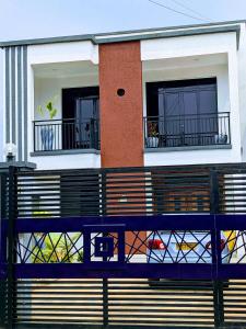 dom z 2 balkonami i pies na balkonie w obiekcie Homestay in Kigali, Rusororo w mieście Masaka