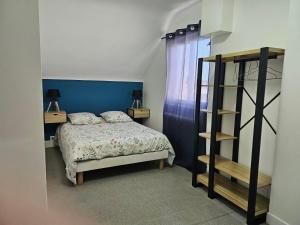 1 dormitorio con cama y estante para libros en Charmante maison familiale, en Montoire-sur-le-Loir
