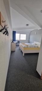 a room with two beds and a living room at Pension Take Off in Gera