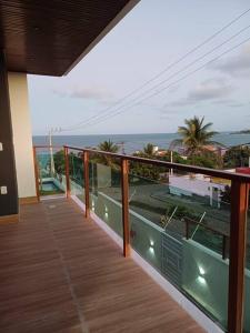 a balcony of a house with a view of the ocean at Casa em condomínio de Cotovelo c/ vista para o mar in Parnamirim