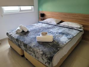 a bedroom with a bed with two towels on it at Palm Sea Suite 17 in Larnaca