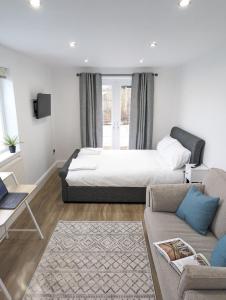 a bedroom with a large bed and a couch at Swan Lake Lodge & free parking in Cardiff