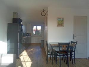 a kitchen and dining room with a table and chairs at Les Noisetiers in Le Loroux-Bottereau