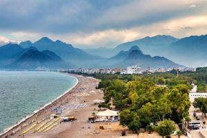 a view of a beach with mountains in the background at Furnished Apartment [Mounthly Discount] D4 in Antalya