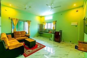 a living room with a couch and a tv at 1BHK villa with swimming pool @ Dreamland in Kottakupam