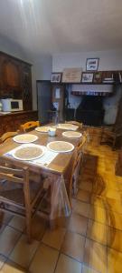 a large wooden table in a room with chairs at gîte la tanière de claire in Ségur