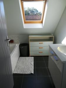 a small bathroom with a sink and a skylight at Maison au calme proche des plages du Golfe du Morbihan in Baden