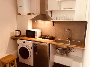 a kitchen with a sink and a washing machine at Econom Hostel in Yerevan