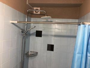 a shower in a bathroom with a blue shower curtain at Econom Hostel in Yerevan
