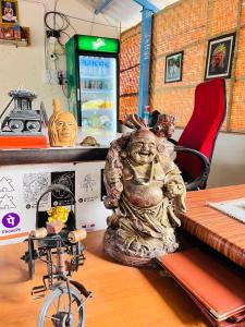 a statue sitting on a table next to a bike at Jungle Tree Hostel Hampi in Hampi