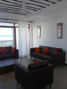 a living room with two couches and a window at Sultan palace. in Mombasa