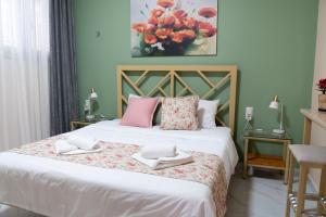 a bedroom with a bed with two towels on it at Anastasia's Luxury House in Kavala