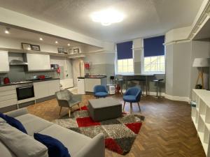 a living room with a couch and chairs and a kitchen at Entire apartment in central Brighton in Brighton & Hove