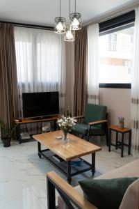 a living room with a television and a table at Anastasia's Luxury House in Kavala