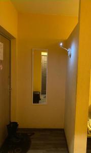 a room with a mirror and a light on the wall at Cat Garden Superior Apartments Riga in Rīga